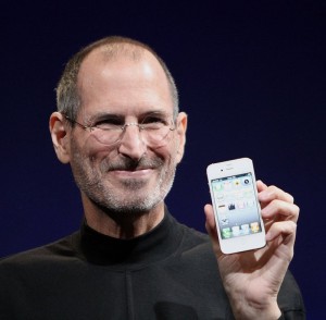 Jobs holding an iPhone 4 at Worldwide Developers Conference 2010.